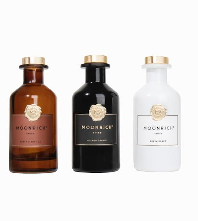Luxurious Moonrich diffuser in black bottle with golden emblem